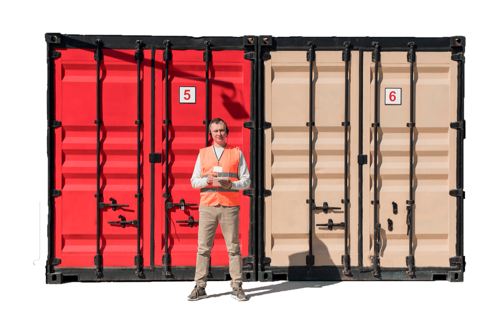 Man with clipboard standing in front of storage containers