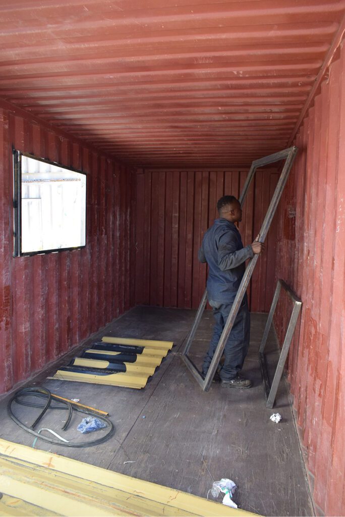 man working on inside of container